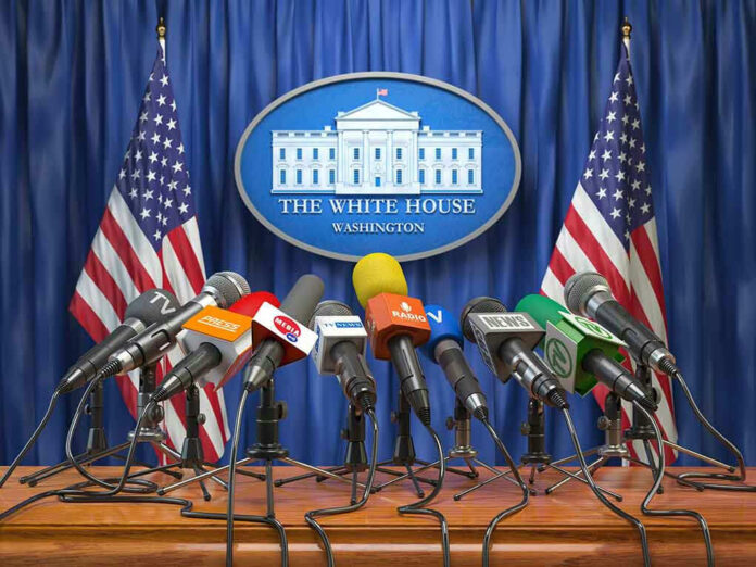 1186435138 Multiple microphones at White House press briefing podium.