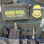 ANOTHER ICE Agent Attacked – Sparks Federal Rampage Border Patrol vest with gear and communication equipment.