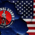 Governor Threatens to Mobilize National Guard Against ICE National Guard logo over a distressed American flag.