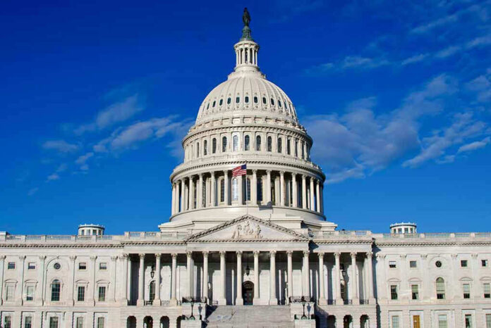 2406965967 US Capitol Building against blue sky.