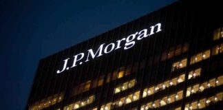 Illuminated J.P. Morgan building at night with visible office windows