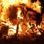 Devastating Fire Leaves 40 DEAD: Shocking Cause Identified! A large fire engulfing debris at night