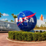 NASA Moon Rocket CRASHES Hours After Launch Vow NASA logo sculpture with spaceship and palm trees.