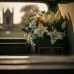 Rock Legend Drops Dead – Chilling Cause REVEALED White flowers in a car with blurred background.