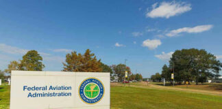 Federal Aviation Administration sign on grassy lawn.