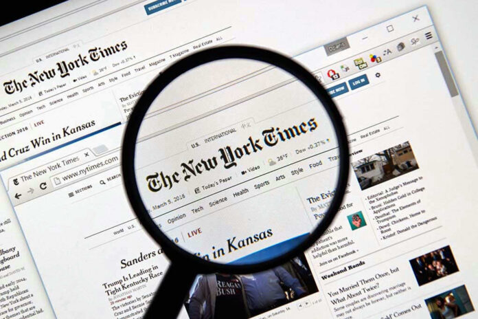 Magnifying glass over The New York Times website.