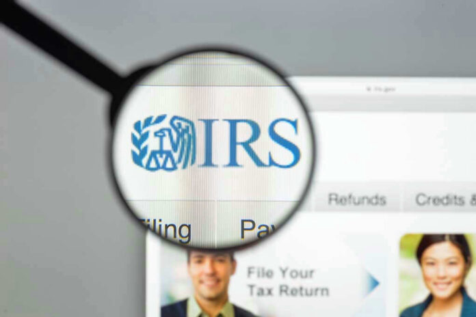 Magnifying glass over IRS website.