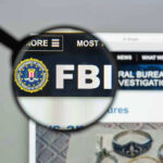 Bomb Torches ICE Warehouse – FBI Investigating Attack FBI website shown through magnifying glass.