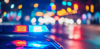 Police car with flashing lights at night.