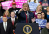 Rally Outrage Erupts Over Trump’s Rally Introducer Person speaking at rally with crowd behind podium
