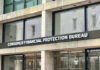 Trump Wants Banks To SNITCH On Immigrants Consumer Financial Protection Bureau building entrance sign.