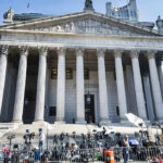 Brutal Roommate Murder: Death Penalty Looms Courthouse facade with media crews setting up outside.