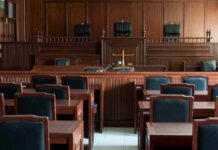 Racist Killer Teens Court Case Takes Drastic Turn! Empty courtroom with wooden furnishings and judges bench.