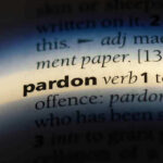 Trump Pardons Blue-Collar Worker After He Did THIS! The word pardon highlighted in a dictionary.