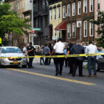 12 DEAD – Coordinated Ambush Shocks City! Police gathered at an urban crime scene.