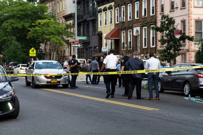 1437619223 Police gathered at an urban crime scene.