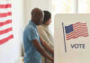 Red-State REWRITES Constitution – New Law Passed! People voting at polling booths with American flag.