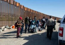 ‘Send Them Back’ Chants Erupt After Strictest-Ever Migration Law PASSED! Border patrol agents interact with a group of people.