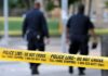 Chilling Massacre – 7 Killed, Including Unborn Baby! Police officers walking past caution tape at a crime scene
