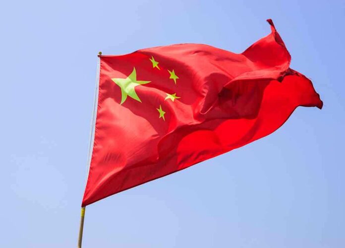shutterstock_151925252 Chinese flag waving against a clear blue sky