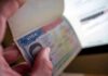 Fans DENIED World Cup Visas – See What They Got Instead! A hand holding an open passport displaying a visa page