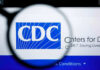 CDC Warns Pet Owners – Flesh-Eating Fly ATTACKING Pets! CDC logo magnified on a screen.