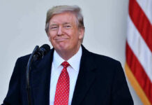 Trump Drops NATO Bombshell Immediately After Landing Man in suit and tie speaking at podium.