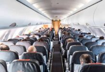 Passenger Invokes Sharia Law – Refuses Sitting Next to Woman Airplane cabin with passengers seated in rows