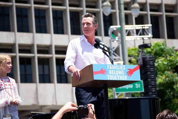 Man speaking at a rally podium outdoors