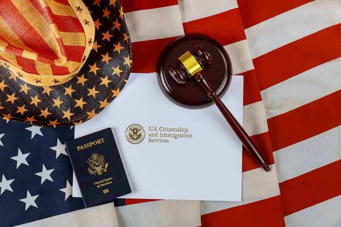 shutterstock_1806488143 U.S. passport, gavel, and USCIS document on American flag