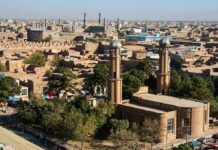 Lt. Governor Aims to BLOCK Public Muslim Prayers Aerial view of a city featuring traditional buildings and minarets