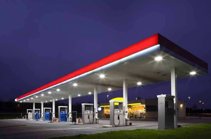 Gas,Station,At,Night A gas station at night with illuminated fuel pumps and a convenience store