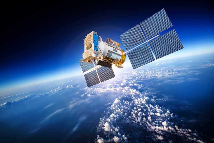 A satellite equipped with solar panels orbiting above the Earth