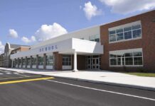Counselor Turned Predator – School Stayed Quiet Modern school building with large windows and a clear sky