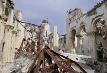 140-Year-Church BURNS – Commie Mayor Refuses to Assist Interior view of a destroyed building with collapsed arches and debris