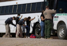 ICE Raid Nabs Illegal During MAGA Voter’s Wedding Border patrol officers investigating people near a bus.