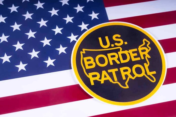 shutterstock_1051372520 U.S. Border Patrol emblem on American flag