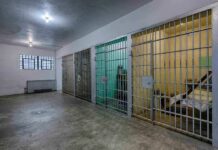 ICE Guards Taunt Starving Kids Interior view of a prison cell block with metal bars and concrete flooring