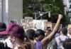 Shock Move: Chauvin Conviction On The Line crowd at a protest holding signs and raising fists