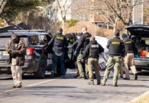 Registered Predator Storms Home – Residents Trapped Police and sheriff officers gather around vehicles on a suburban street