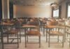 State Slams Door on Undocumented Students Empty classroom with rows of wooden desks and chairs