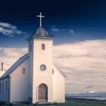 Woke Pastor Declares Lazarus Was Gay Because Jesus Called for Him to ‘Come Out’ White countryside church with steeple and cross under a dramatic sky