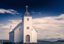 Woke Pastor Declares Lazarus Was Gay Because Jesus Called for Him to ‘Come Out’ White countryside church with steeple and cross under a dramatic sky