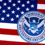 ICE Gunfire Ignites Austin Uproar U.S. immigration and customs enforcement seal on American flag