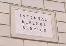 Tax-The-Rich Crusader Candidate Hit With IRS Tab Internal Revenue Service building sign on a stone wall