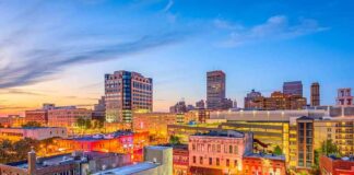 City skyline at dusk with lit streets and buildings