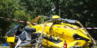 yellow helicopter crash scene on grassy field