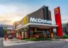 McDonald's restaurant exterior with drive-thru at sunset