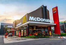 McDonald's restaurant exterior with drive-thru at sunset