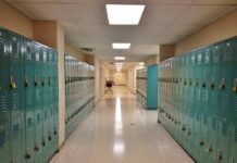 School hallway with rows of teal lockers